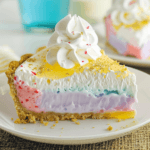 Colorful Easter Jello Pie Recipe slice with whipped cream and gold sprinkles